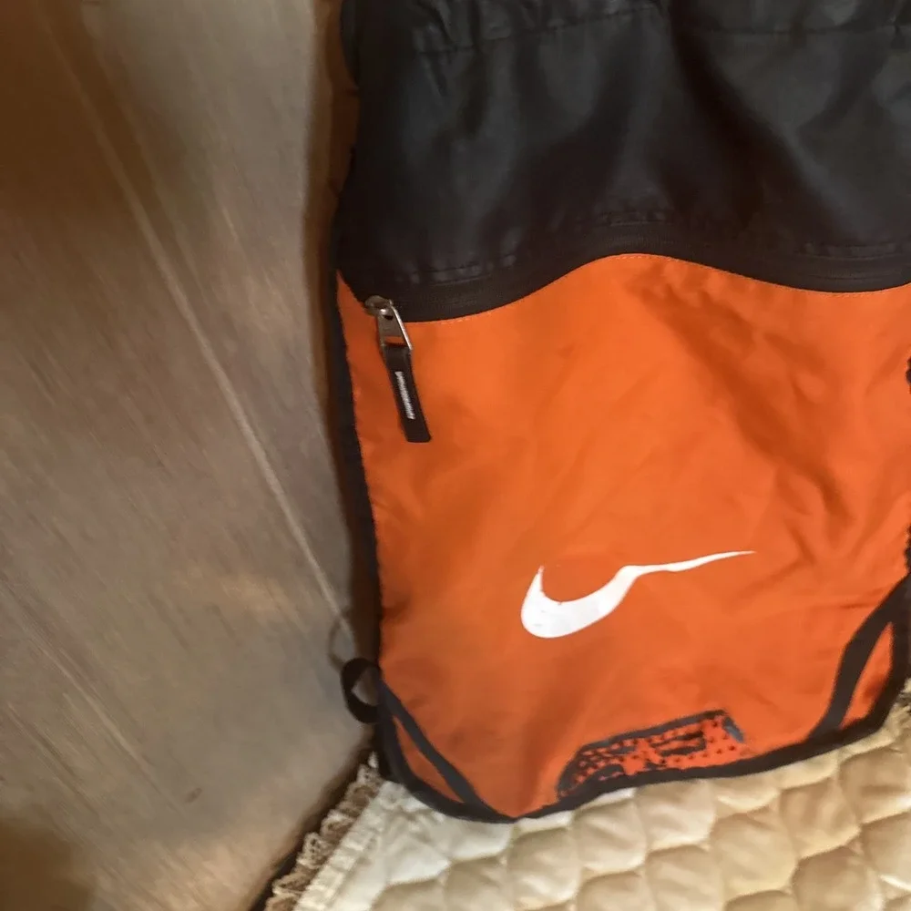 Nike Brasilia 9.5 Training Gym Sack featuring a vibrant‎ orange White Swoosh